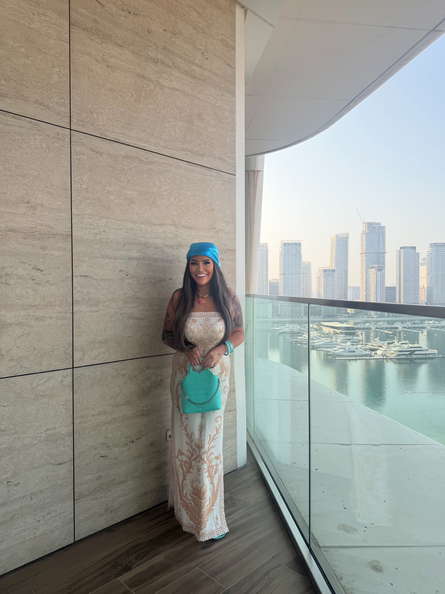 Lucy on a balcony overlooking Dubai Marina
